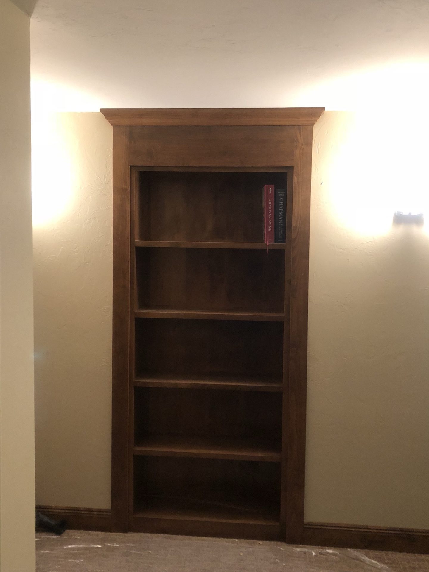 Custom built-in wood bookshelf with crown molding