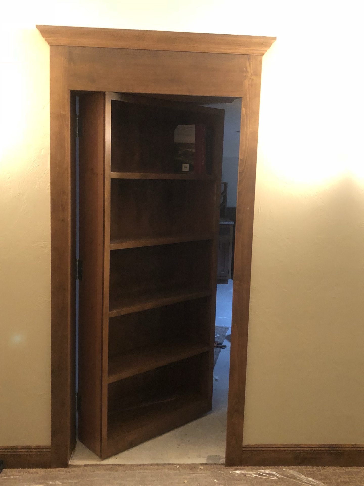 Hidden bookshelf door opening to a concealed room