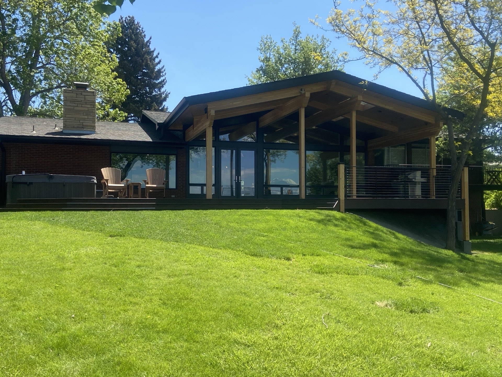 Lakefront custom home with covered cedar patio addition and hot tub