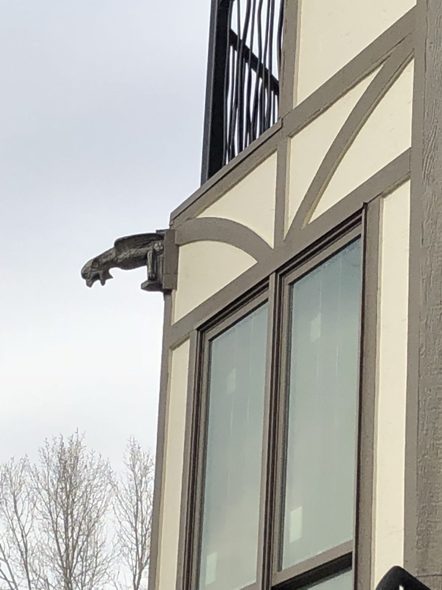 Tudor-style exterior with decorative gargoyle bracket and half-timber trim