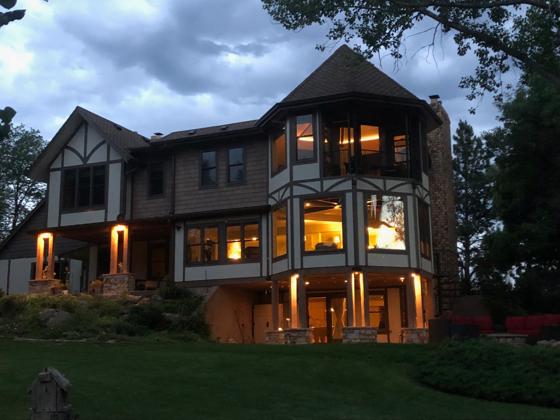 Custom Tudor-style home at dusk